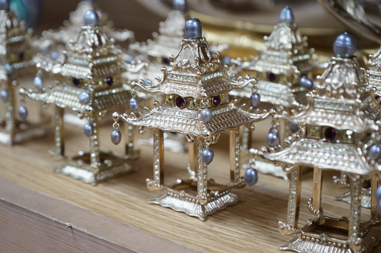 A group of L’objet gilt metal table decorations; twelve decorative ‘Chinese pagoda’ freshwater pearl and Swarovski crystal mounted napkin rings, and two dishes on faux bamboo stands. Condition - good.